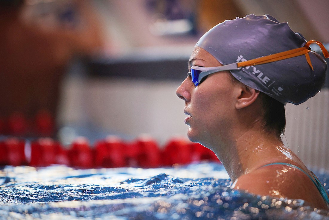 a swimmer wearing goggles and a swim hat with the iSTYLE logo