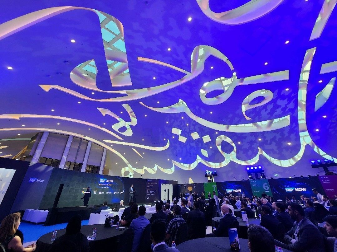 technology event held in a fantastic blue dome filled with arabic calligraphy