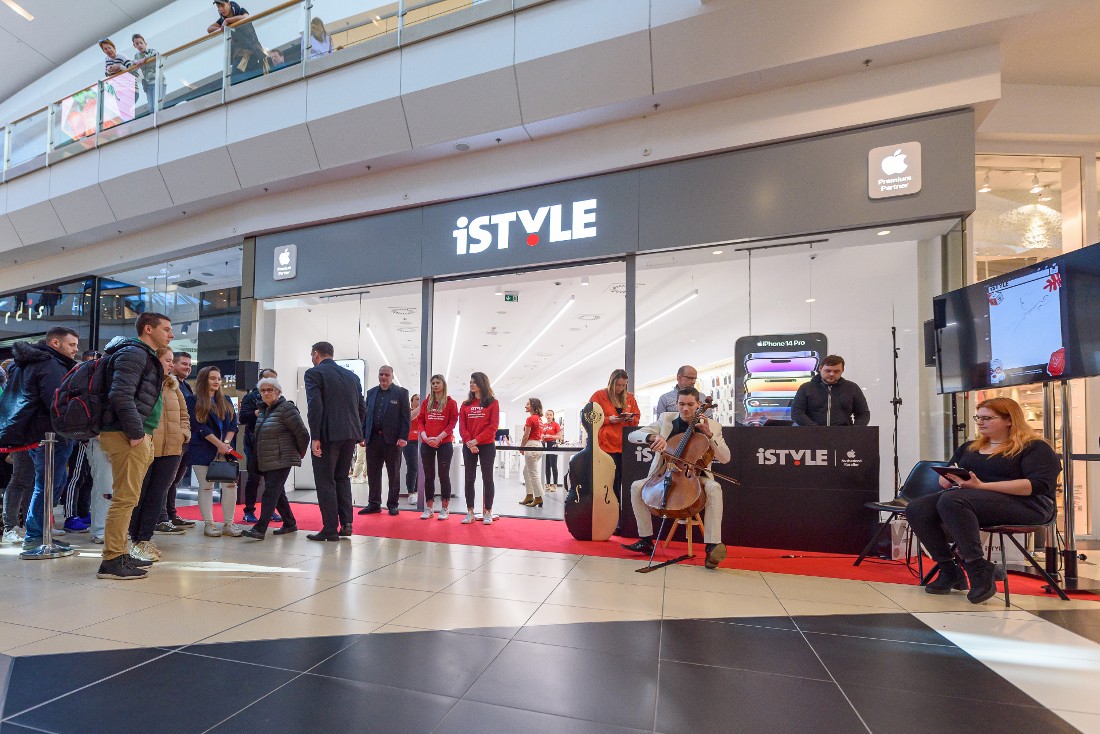people are seen waiting to enter a hi-tech store at an opening event