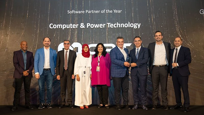 nine people celebrate an award on stage at a presentation