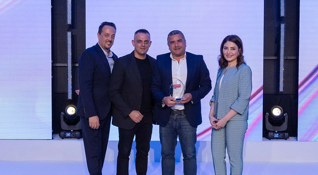 Four people on stage at an award presentation event