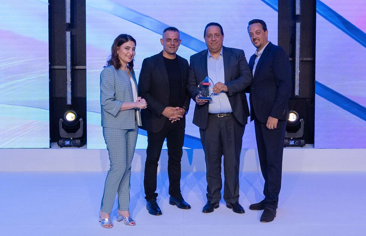 four people on a presentation stage accepting an award