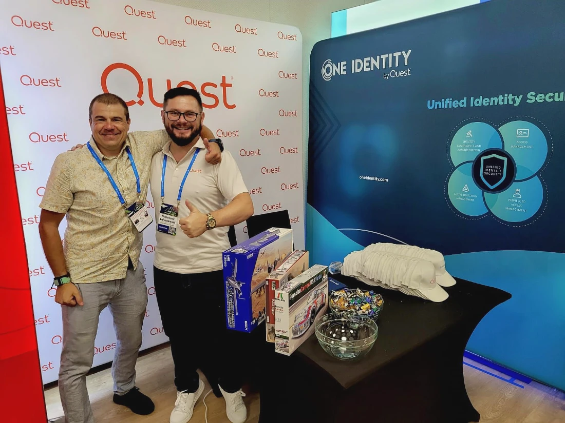 two men are seen on a software company kiosk at a conference