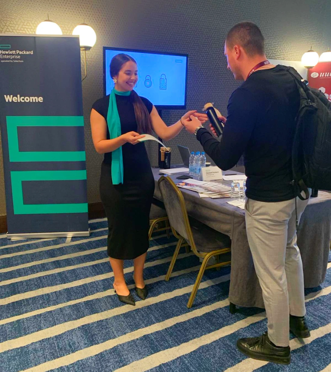 a woman and a man are seen at a hi-tech event